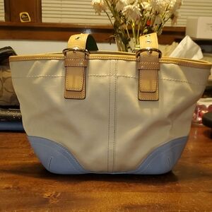 Coach brand Tan and blue leather hand bag.